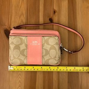 Pink and tan signature Coach wristlet